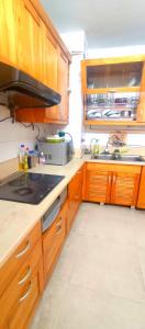 a kitchen with wooden cabinets and a sink at GuInn in Hanoi +13 photos