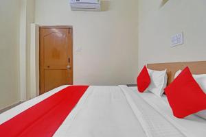 a bedroom with a bed with red and white pillows at 80983G RBS Square Langer Houz in Haidar Sāhibgūda