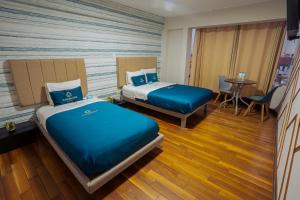 Postel nebo postele na pokoji v ubytování Golden Mar Hotel