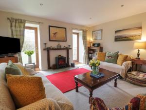a living room with two couches and a coffee table at The Garden House in Chirnside