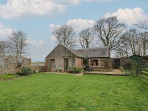 an old stone house with a large yard at The Garden House in Chirnside