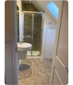 a bathroom with a sink and a shower at Studio one bedroom En-Suite with Kitchenette in Easthampstead