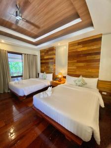 a hotel room with two beds and a window at The Nest El Nido Beach Resort in El Nido