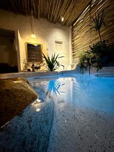 a swimming pool in a house with lights on the floor at Rosarii Pacis Villa - Venuestay in Thôn Bình Hưng