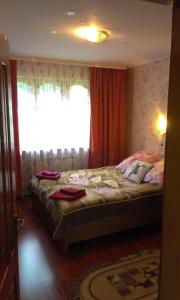 a bedroom with a bed with a large window at Boykivska Familiya in Yaremche