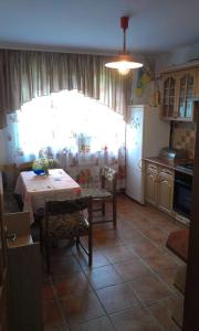 a kitchen with a table and a kitchen with a window at Boykivska Familiya in Yaremche