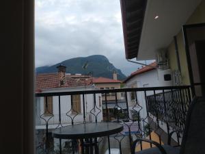 a balcony with tables and a view of a mountain at MENTA in Litochoro