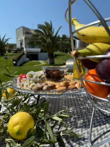 a tray of food on a table with bananas and fruit at Possidi Hiliadou Boutique Resort in Possidi