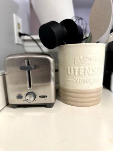 a toaster and a toaster sitting on a counter at Cozy Downtown Oasis in Hartford