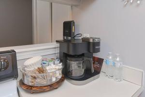 a coffee maker sitting on a counter in a kitchen at Cozy Downtown Oasis in Hartford