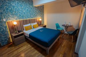 Postel nebo postele na pokoji v ubytování Golden Mar Hotel