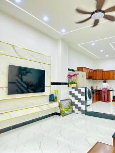 a living room with a large flat screen tv on the wall at Villa Quy Nhơn Gần Biển Gần Trung Tâm - Biệt Thự Quy Nhơn Gần Biển in Quy Nhon