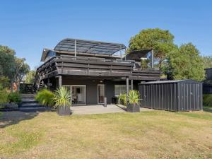 a house with a solarium on top of it at Sol Vista Paku - Pauanui Holiday Home in Pauanui