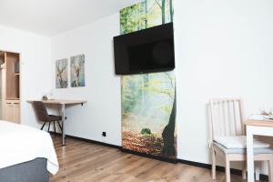 a living room with a tv on a wall at Ferienwohnung Kranichsee 2 in Goslar
