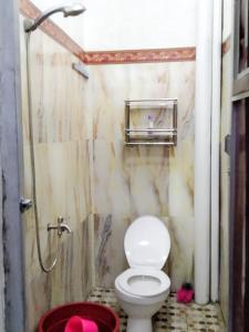 a bathroom with a toilet and a shower at Home stay & Kost syariah SONY CA E.15 in Batu Hampar