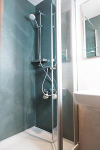 a glass shower in a bathroom with a sink at Ferienwohnung Kranichsee 2 in Goslar