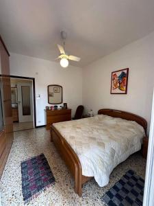 a bedroom with a bed and a ceiling fan at Vicino al mare in Borgio Verezzi