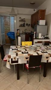 a kitchen with a large wooden table with chairs at Vicino al mare in Borgio Verezzi