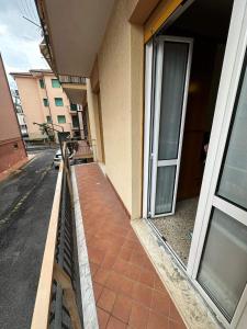 a balcony of a building with a glass door at Vicino al mare in Borgio Verezzi