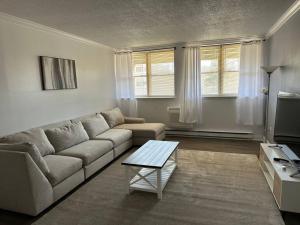 a living room with a couch and a coffee table at Cozy 1BR Condo in West Hartford
