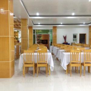 a dining room with tables and chairs in a room at Cherry's CourtYard in Puerto Princesa City