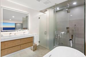 a bathroom with a glass shower and a sink at Aquazzura - By Stay Awhile Villas in Malibu +56 photos