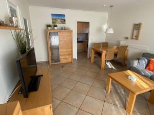 a living room with a couch and a table at Traumapartment Haus Stoertebeker - Strandnah und trotzdem zentral in Westerland