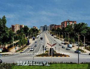a highway with cars driving on it in a city at Hotel Tajikgrey Dushanbe in Dushanbe