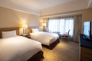 Kobe Bay Sheraton Hotel & Towers tesisinde bir odada yatak veya yataklar