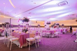 a banquet hall with tables and chairs with purple tablecloths at Go Hotels Iligan in Iligan City