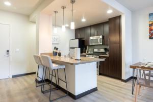 a kitchen with a large island with bar stools at Charming Luxury Apartment with Hollywood Sign View in Los Angeles