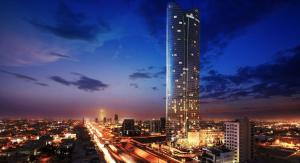 ein großer Wolkenkratzer in einer Stadt in der Nacht in der Unterkunft Luxury apartment Rafal Tower شقة فاخرة برج رافال in Riad