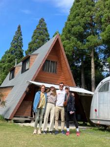 a group of people standing in front of a house at Guesthouse Coco Garage in Kirishima