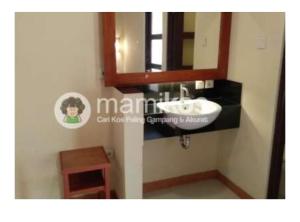 a bathroom with a sink and a mirror at Familytel Bali in Jimbaran