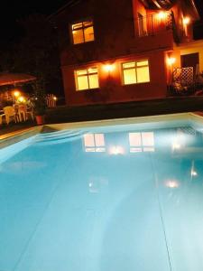 een groot zwembad voor een huis 's nachts bij Ferienhaus mit Privatpool für 17 Personen ca 230 qm in Panicagliora, Toskana Provinz Pistoia in Serra Pistoiese