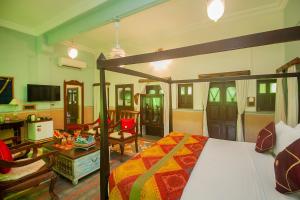 a bedroom with a bed and a living room at Amritara Manak Haveli, Jodhpur in Jodhpur +118 photos