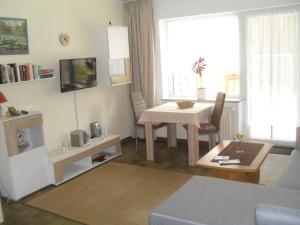 a living room with a table and a table and chairs at Haus Rosi in Friedrichskoog-Spitz