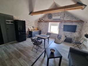 a living room with a hammock hanging from the ceiling at Vila Kyra in Rtina +19 photos