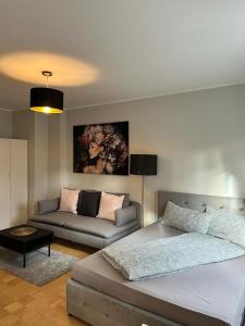 a living room with a bed and a couch at AMAROOM apartments 2 in Karlsruhe