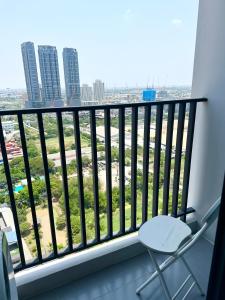 a balcony with a chair and a view of a city at Private 1 Bedroom at Niche Mono Mega Space Bangna in Bangna