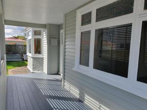 a front porch of a house with windows at Dog-friendly in Waterloo in Lower Hutt
