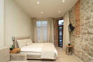 מיטה או מיטות בחדר ב-MONOPATI HOUSE