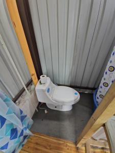 a small bathroom with a toilet in a room at Otto’s House in Guatemala