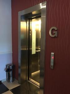 a elevator in a building with a c on the wall at AVARIA SIGNATURE in Malacca