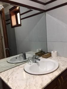 a bathroom counter with a sink and a mirror at Green Bud hostel and homestay in Hoi An