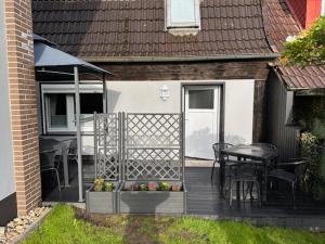a wooden deck with a table and chairs on a house at Bauernhaus nähe Lamspringe in Winzenburg