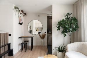 a living room with a mirror and a table at Home Away Apartments Stockholm in Stockholm