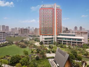 an aerial view of a city with a tall building at Pullman Haining in Haining