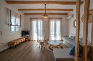 a living room with a bed and a table in it at Epithea Suites Kythnos 5 με ιδιωτική πισίνα in Kithnos
