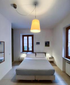 a bedroom with two beds and a light fixture at B&B Ponte Manin in Verona